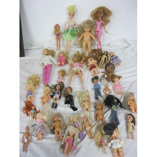 29 - Two boxes of various small and large plastic and decorative dolls, some a/f