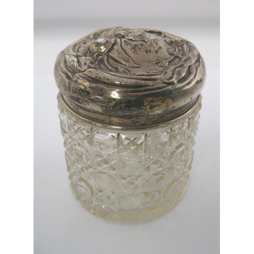 54 - An Art Nouveau silver lidded jar embossed with floral scene, hallmarked for Chester 1909