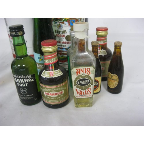 54 - An assortment of alcohol comprising a bottle of Ruby Port, a bottle of Martini and an assortment of ... 