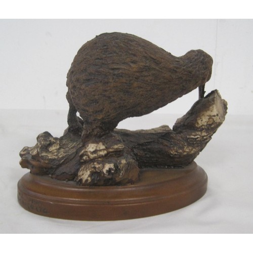 76 - Allan Davey & Co resin figure of kiwi, modelled on a twisted branch on oval base. Title and maker's ... 