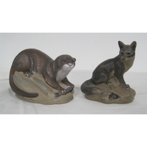 110 - Two Poole Pottery stoneware animal figures - a polychrome otter modelled with fish, and a fox with r... 