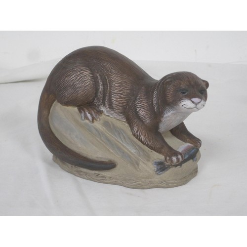 110 - Two Poole Pottery stoneware animal figures - a polychrome otter modelled with fish, and a fox with r... 