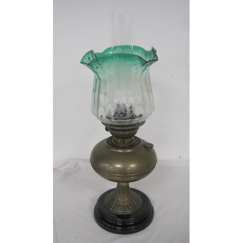 114 - An antique Veritas oil lamp, brass stem and reservoir, etched glass shade graduating from green to c... 