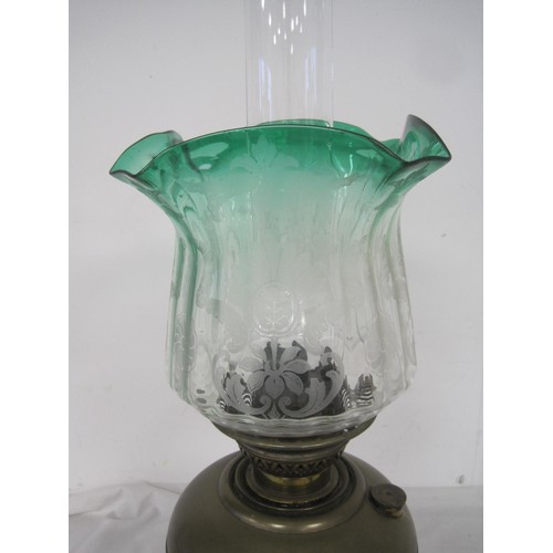 114 - An antique Veritas oil lamp, brass stem and reservoir, etched glass shade graduating from green to c... 