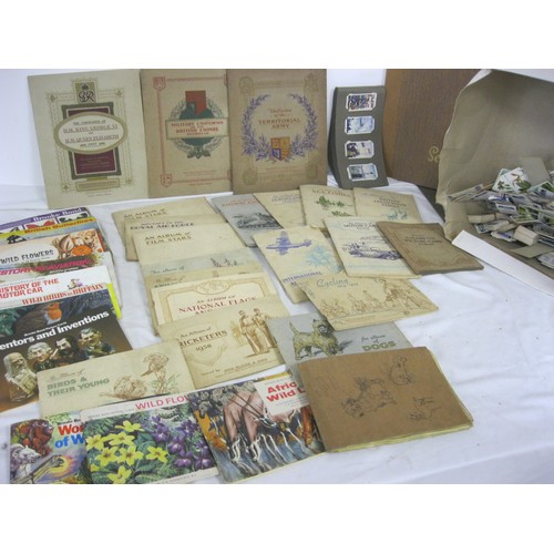 13 - A large quantity of cigarette cards and tea and trade cards mostly in albums, some loose