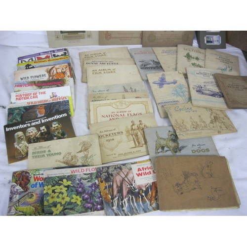 13 - A large quantity of cigarette cards and tea and trade cards mostly in albums, some loose