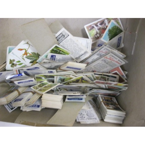 13 - A large quantity of cigarette cards and tea and trade cards mostly in albums, some loose