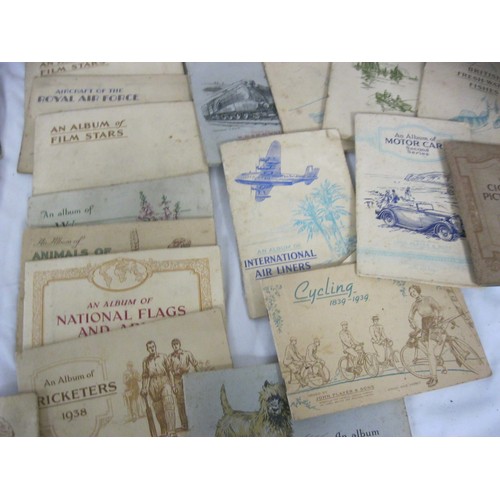 13 - A large quantity of cigarette cards and tea and trade cards mostly in albums, some loose