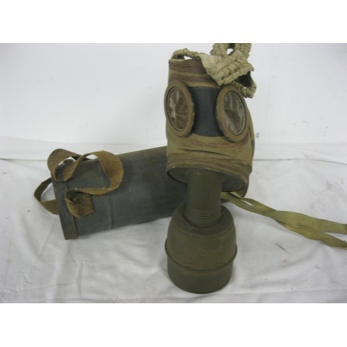 109 - A WW2 French gas mask, complete with original tin, marked C.P.1938-C, in solid overall condition, co... 