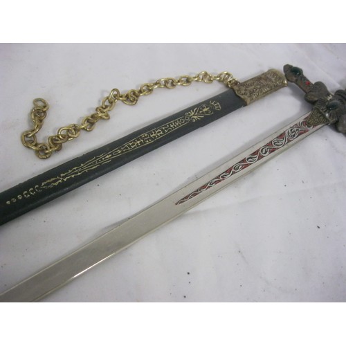 120 - A vintage Masonic sword in scabbard, imitation gemstones to guard and hilt, with mounting chain