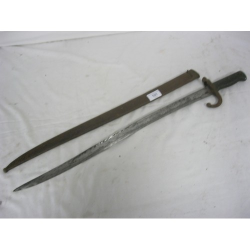 121 - A French 1868 Pattern Chassepot bayonet in scabbard, intact, blade well cared for and oiled, surface... 