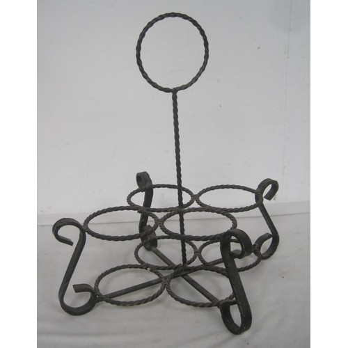 133 - A useful and decorative wrought metal four-section wine bottle carrier