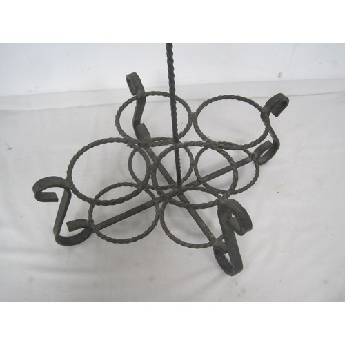 133 - A useful and decorative wrought metal four-section wine bottle carrier