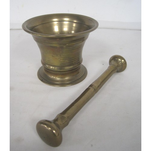 116 - A brass mortar and pestle (length of pestle 19cm), and two engraved brass goblets