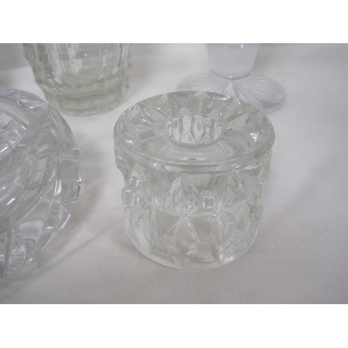 146 - A heavy cut glass ashtray, together with a glass candle holder, and three vases