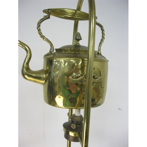 94 - A brass kettle and burner on an ornate brass stand