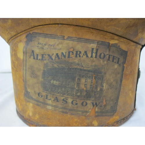 98 - A Victorian leather top hat bucket and contents, ie a hat!