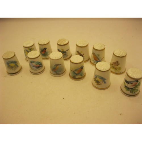 102 - 12 Royal Worcester thimbles each hand decorated with different birds, some signed