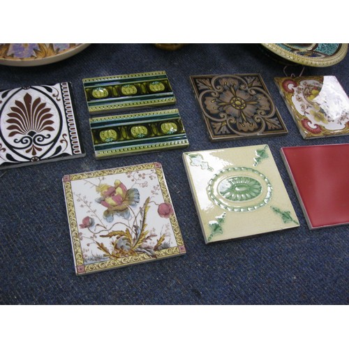 162 - A pair of pieces of Victorian majolica and a selection of antique tiles including Minton's.