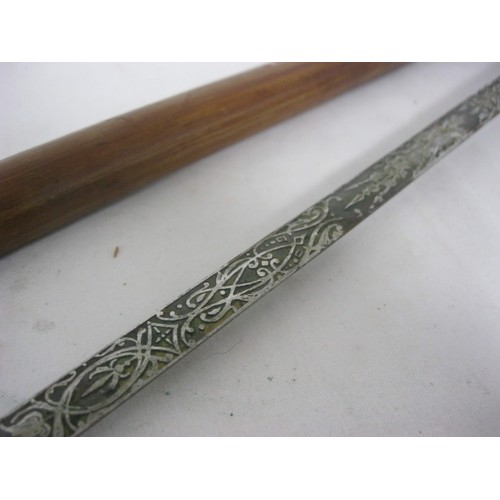 34 - 489 A Spanish cane shafted sword stick with a 69cms double sided finely etched flat blade marked TOL... 