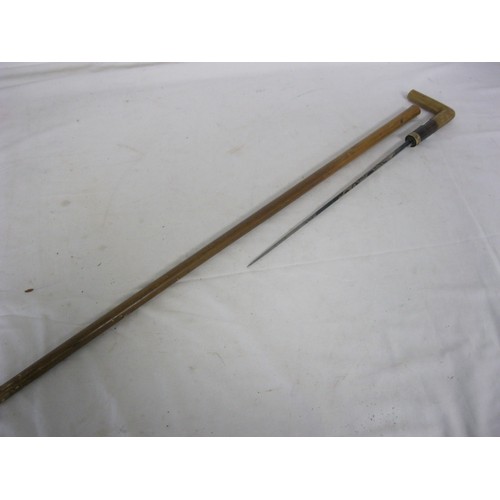 35 - 490 A malacca cane shafted sword stick with a fine 35.5cms diamond section blue decorated blade and ... 