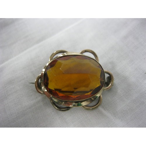 76 - A large amber brooch