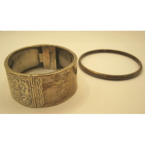 113 - Two silver bangles one hinged the other solid .
Total weight 52.18