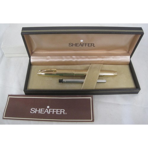 123 - A Sheaffer white dot gold-plated fountain pen with nib stamped 585 14K, ribbed barrel and lid, in pr... 