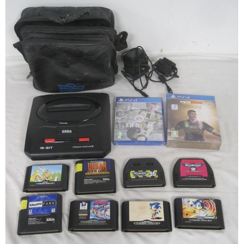 142 - Sega mega drive II with power adaptors, a soft carry case, games and two PS4 football Games. Sega ga... 