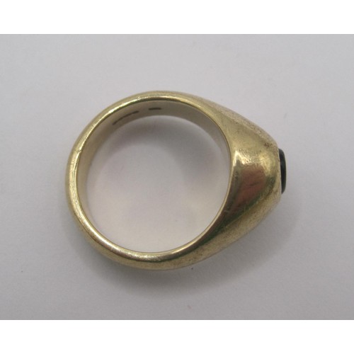 155 - A substantial 9 carat gold gents signet ring set with an un-engraved oval dark stone in a raised set... 