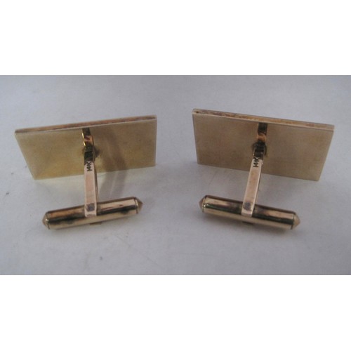 169 - A pair of substantial and distinctive gold cufflinks with gold-plated toggles. The rectangular faces... 