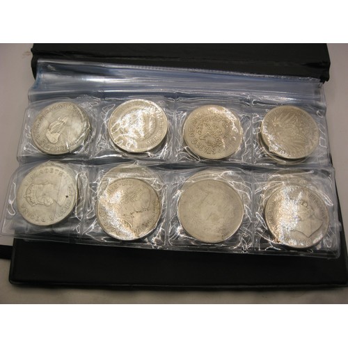 182 - A cased set of 80 reproductions of famous world coinage in white metal including Morgan dollars etc