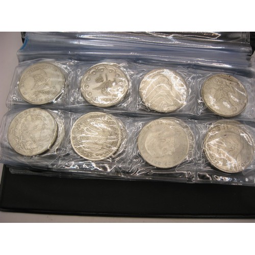 182 - A cased set of 80 reproductions of famous world coinage in white metal including Morgan dollars etc