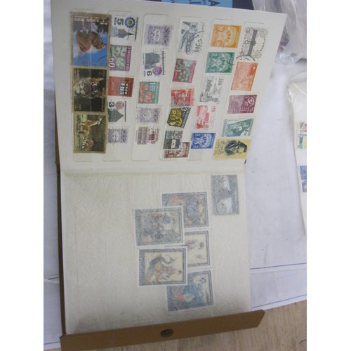 200 - Two Stamp Albums Containing Various World Stamps. A Bag Containing a Mixture of Interesting First Da... 