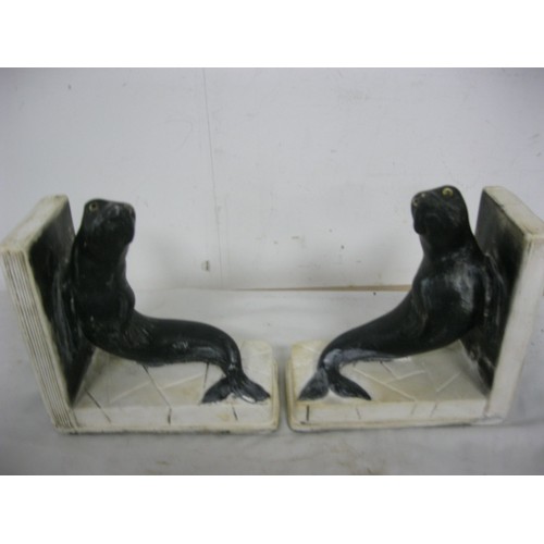 222 - A pair of Art Deco sealion figural bookends with glass eyes