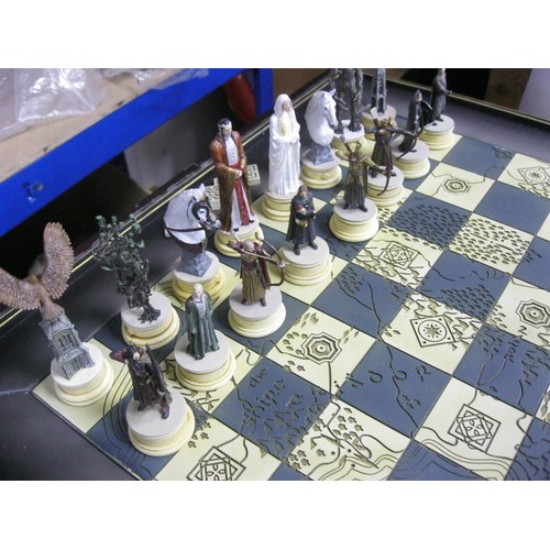 162 - A floor-standing Lord of the Rings chess set on table board, in excellent condition, the chess piece... 