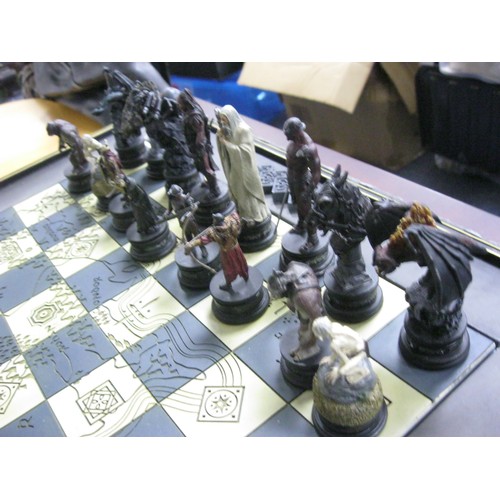 162 - A floor-standing Lord of the Rings chess set on table board, in excellent condition, the chess piece... 