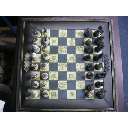 162 - A floor-standing Lord of the Rings chess set on table board, in excellent condition, the chess piece... 