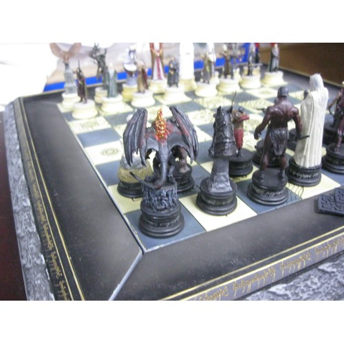 162 - A floor-standing Lord of the Rings chess set on table board, in excellent condition, the chess piece... 