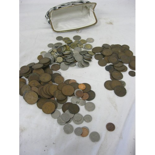 232 - An assortment of mixed coinage, primarily British but some foreign, contained within an old purse