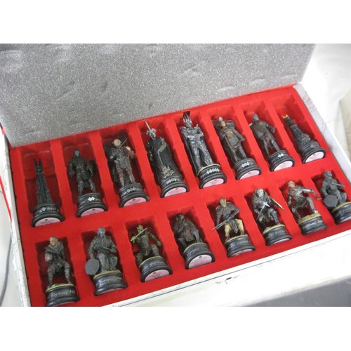 163 - A Lord of the Rings chess set, cased and in mint condition: 2 cases, one for black, one for white, t... 