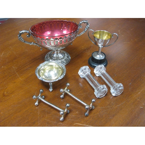 47 - A silver plate bon bon dish with cranberry glass inner, 2 pairs of knife rests, a small tennis troph... 