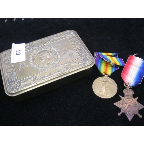 61 - A 1914 Queen Mary's Christmas Tin in good order containing a pair of WW1 medals - 1914/15 Star and a... 