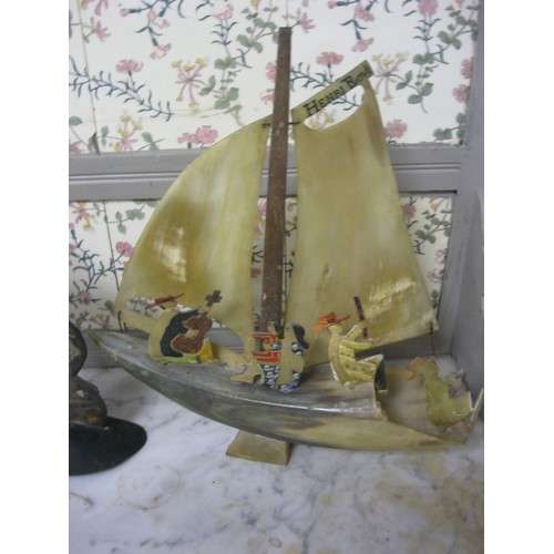 93 - A vintage sailing ship made of horn and a pair of Oriental carved scenes in horn, mounted on wooden ... 