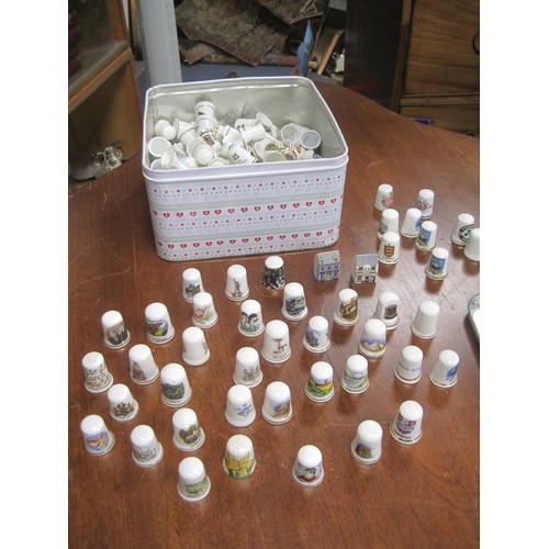 80 - Tin with a large assortment of porcelain Thimbles