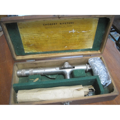 126 - A vintage Chobert aviation rivet gun in wooden fitted case, with a number of rivets, 1944 dated