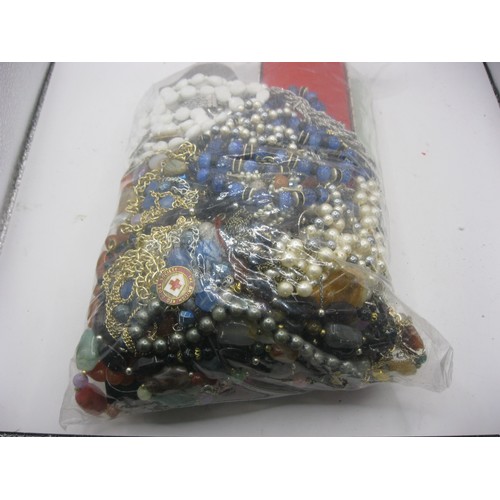 110 - A bag of costume jewellery, mainly necklaces, includes a Criptons Commercial College enamel badge, a... 