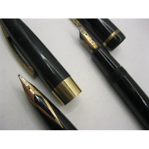 216 - A US made Shaeffer white dot ink pen with 14 carat gold nib, plus a Parker Duofold ink pen also with... 