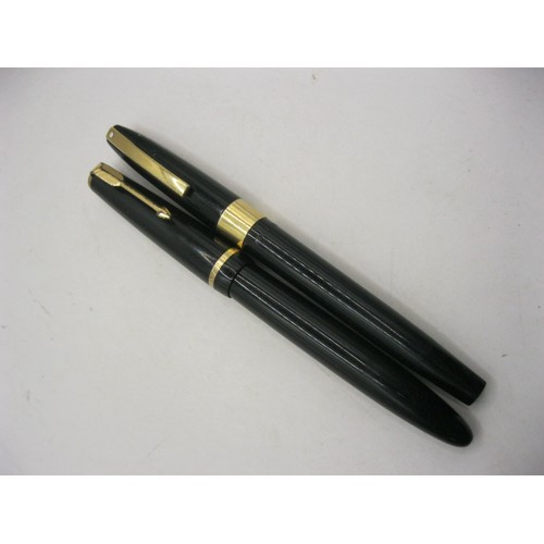 216 - A US made Shaeffer white dot ink pen with 14 carat gold nib, plus a Parker Duofold ink pen also with... 