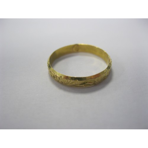 222 - A small yellow metal ring, has been re-sized, with attactive floral patterning, marked to the interi... 